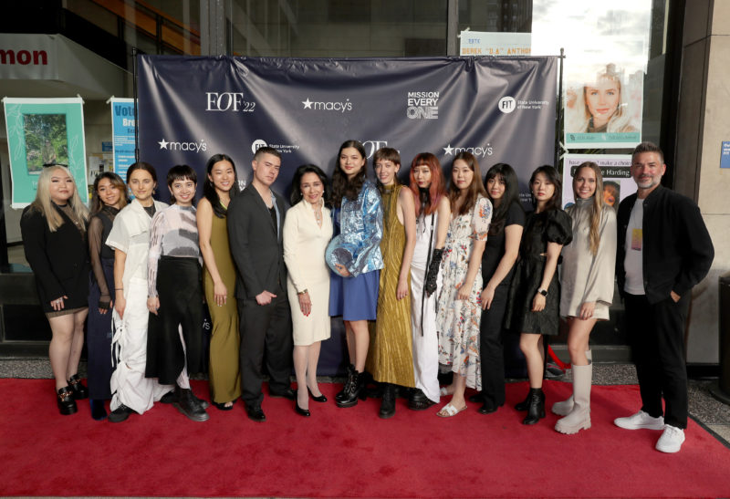 students standing in front of a backdrop
