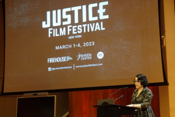 Nicole Finigan Ndzibah speaking at a podium at the Justice Film Festival
