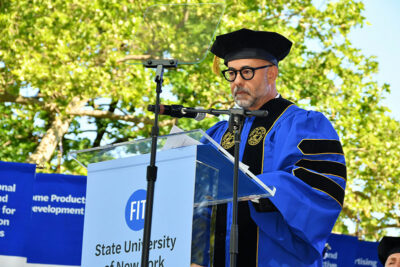 Francisco Costa, Fashion Design ’90, founder and head of Costa Brazil, and former creative director for women’s wear at Calvin Klein, standing at a podium addressing the graduates