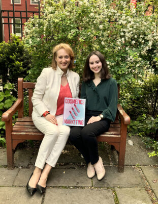 Delphine Horvath and Lindsay Karchin hold their book on a bench
