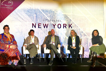 Five people on a stage; Sonja Chapman is second from right.