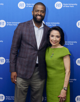 Bakari Sellers stands with President Brown in front of an FIT logo step and repeat