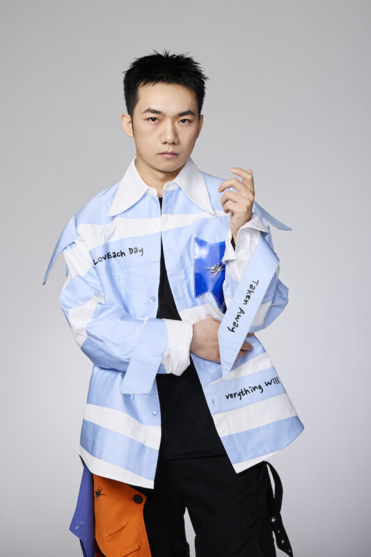 Yuchen Han wearing clothes he designed